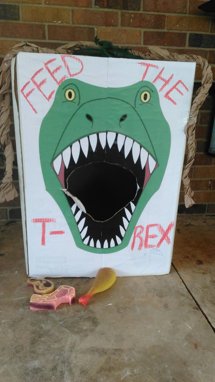 there is a cardboard box with a dinosaur head on it and the words feed the t - rex