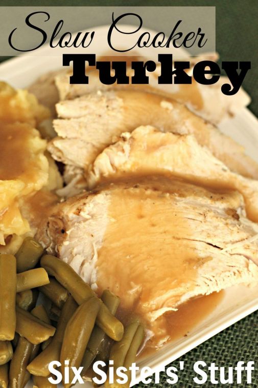 a white plate topped with green beans and turkey