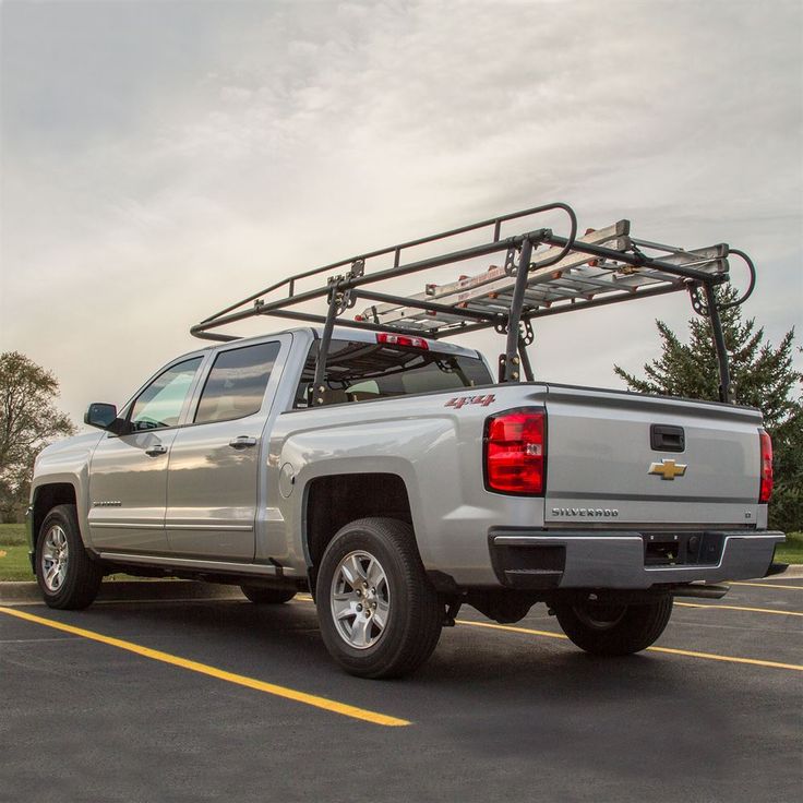 a silver truck with a ski rack on it's back