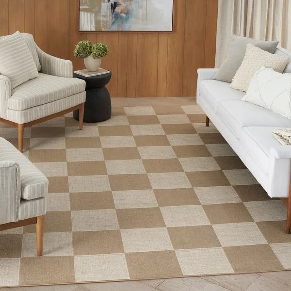 a living room filled with furniture and a checkered rug