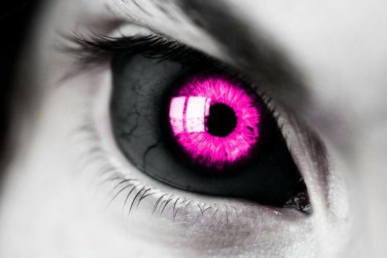 a close up of a person's eye with pink iris