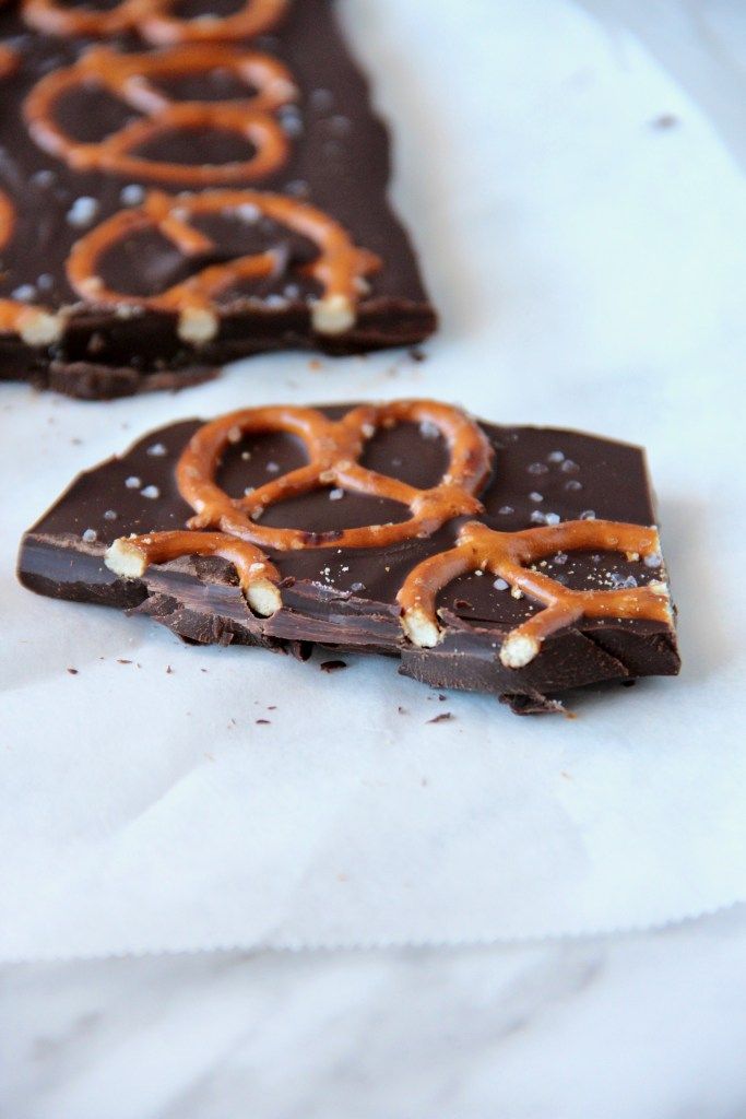 two pieces of chocolate with pretzels on top