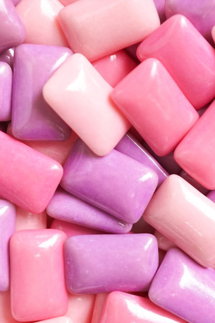 there are many pink and purple candy pieces