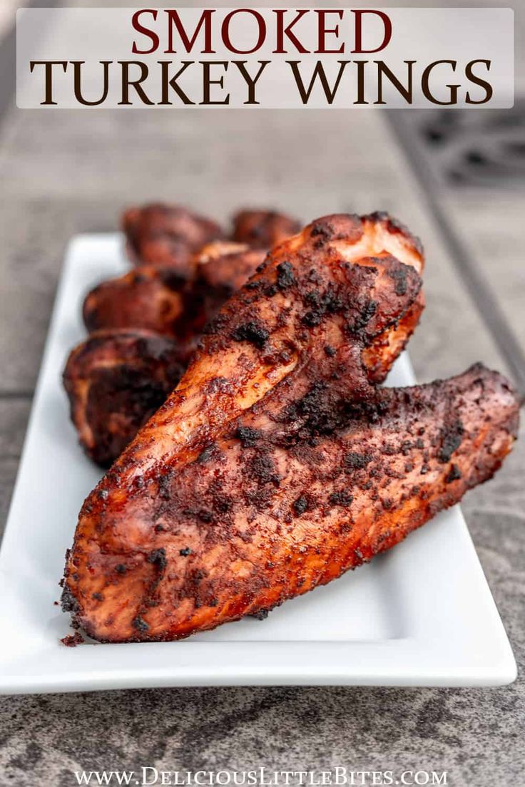 grilled chicken wings on a white plate with text overlay that reads how to make smoked turkey wings