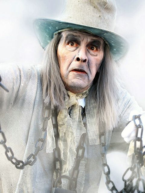 an old man with long hair wearing a hat and chain around his neck