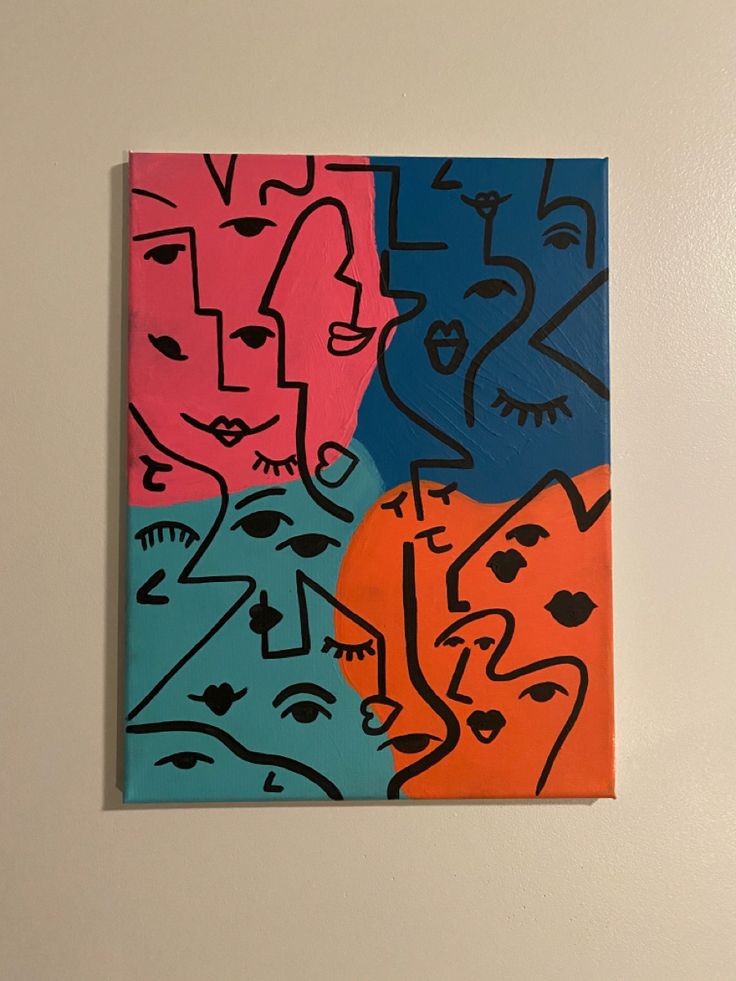 a painting on the wall with different colored faces