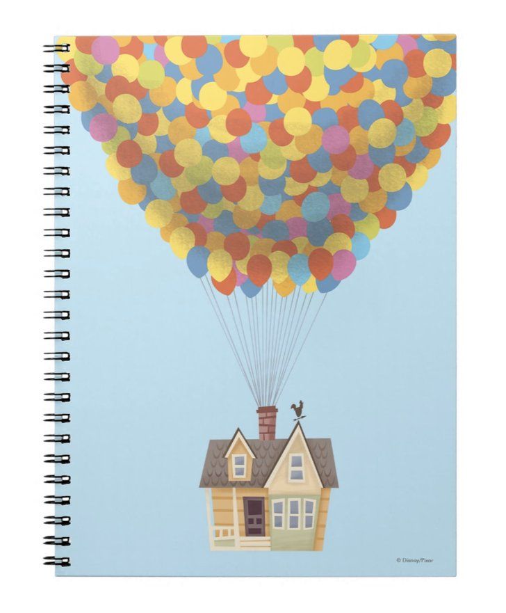 a house with a bunch of balloons attached to it's roof is shown in this spiral notebook