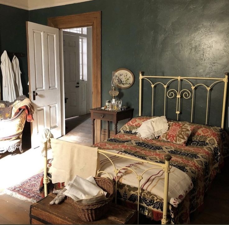 a bedroom with green walls and an iron bed