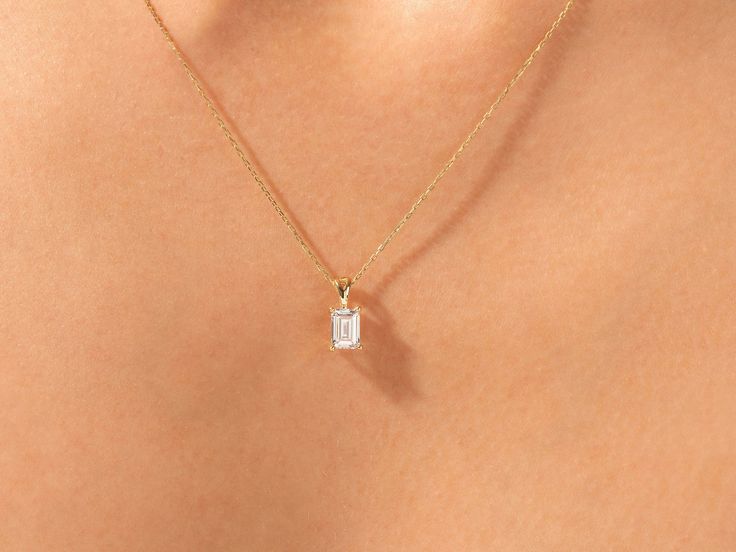 ✥The Emerald Cut Solitaire Moissanite Diamond Pendant Necklace is a captivating piece that exudes elegance and sophistication. Featuring a stunning emerald-cut moissanite diamond as the centerpiece, this necklace is a timeless and classic accessory that adds a touch of glamour to any outfit. The emerald-cut diamond is known for its sleek and elongated shape, which enhances its brilliance and sparkle. Set in a delicate pendant and suspended from a fine chain, this necklace is perfect for adding a touch of luxury to your everyday look or for complementing a formal ensemble. Whether worn alone or layered with other necklaces, this pendant is sure to make a statement and become a cherished piece in your jewelry collection.Stone Details:Type: Solitaire Necklace Stone Type: MoissaniteStone Cut: Emerald Cut Diamond Necklace, Emerald Cut Necklace, Delicate Pendant, Chain Lock, Solitaire Necklace, Emerald Cut Moissanite, Necklace Stone, Solitaire Pendant Necklace, Diamond Solitaire Necklace