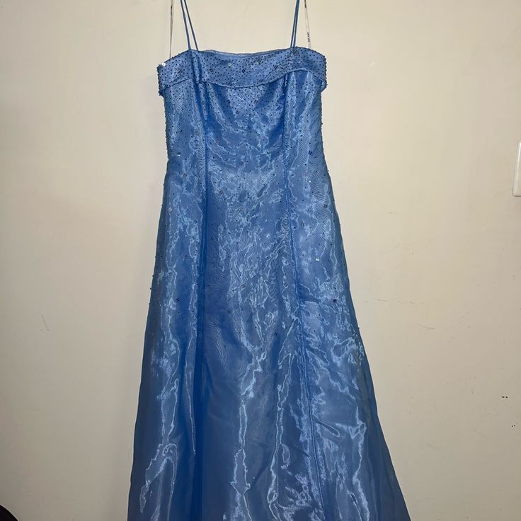 This Beautiful Gown Has Never Been Worn. No Tags Anymore But It Is Flawless And The Most Perfect Shade Between Blue And Lavender. Size - 9/10 Juniors Brand - Delaru The Dress Has Tulle Built In To Keep A Beautiful Shape Throughout The Night. The Outside Of The Dress Is Embellished With Beautiful Rhinestones And Sequins To Shine With Every Move You Make. This Dress Photographs Beautifully. Light Blue Evening Dress For Debutante Ball, Blue Dress With Lined Bodice For Prom Season, Blue Prom Dress With Lined Bodice, Blue Sleeveless Ball Gown For Evening, Blue Evening Dress For Debutante Ball, Formal Light Blue Ball Gown, Blue Maxi Dress With Lined Bodice, Blue Evening Dress For Debutante Ball In Spring, Spring Blue Evening Dress For Debutante Ball