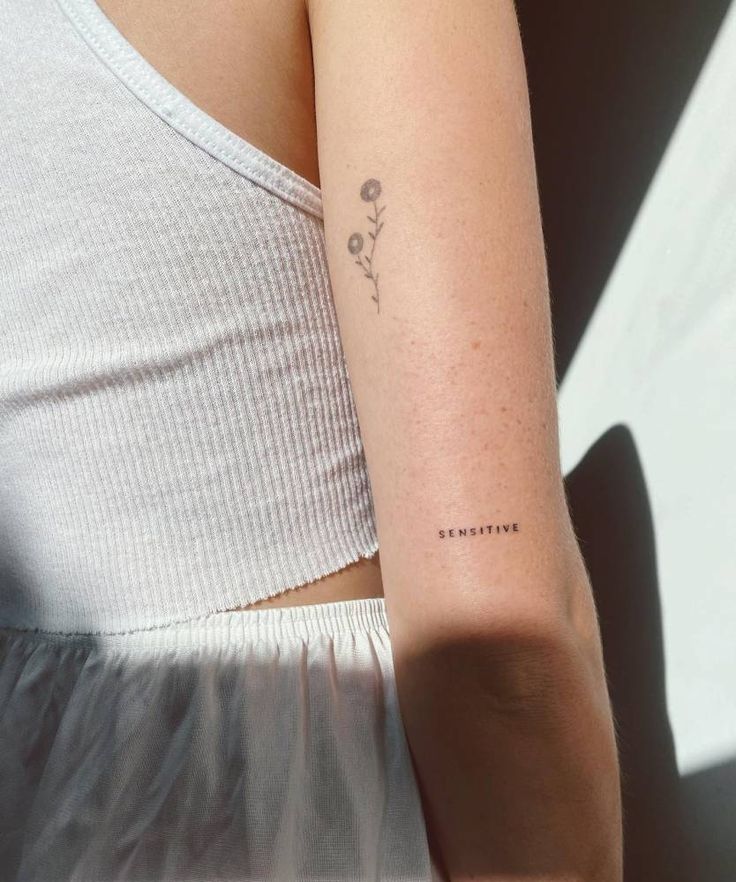 a woman with a small tattoo on her arm