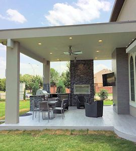 an outdoor living area with patio furniture and grill