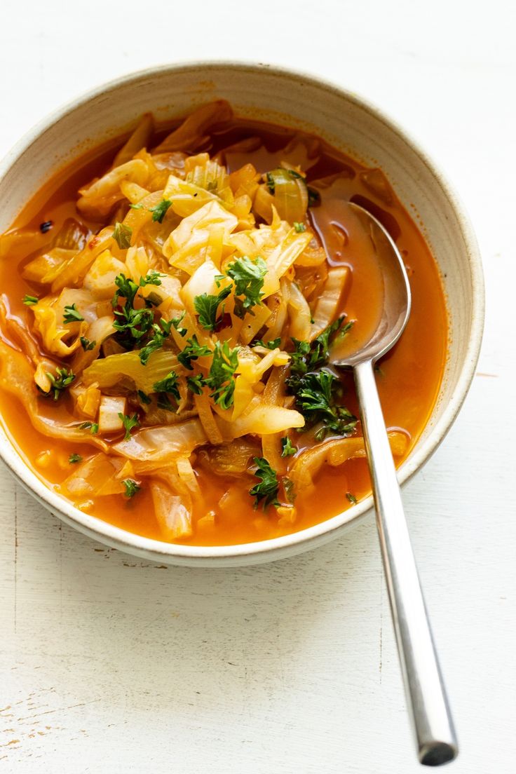 a white bowl filled with soup on top of a table