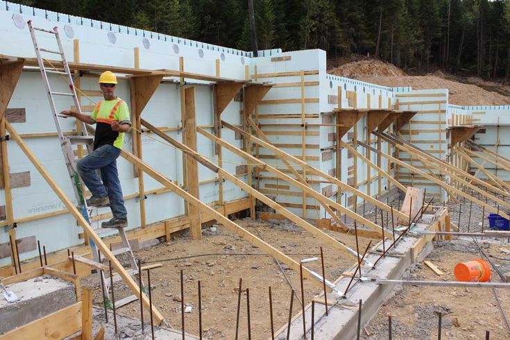 construction workers working on the foundation of a building