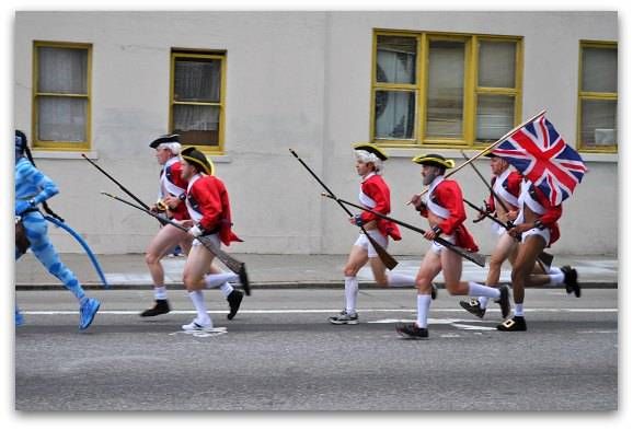 men in british uniforms marching down the street