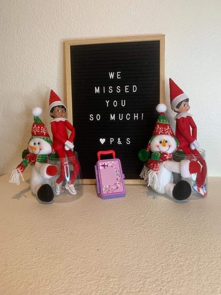 three elf figurines sitting next to a chalkboard with the words we missed you so much