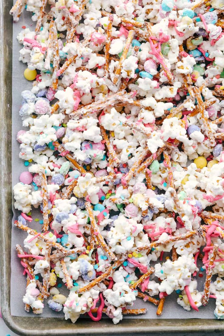 sprinkles and marshmallows are mixed together on a baking sheet