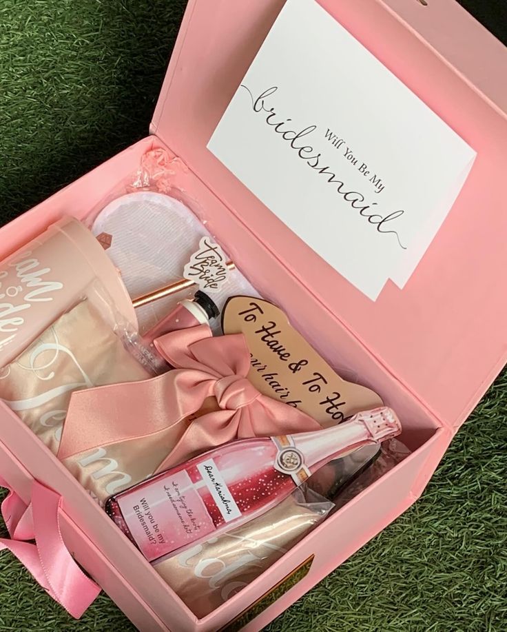 a pink box filled with personal care items on top of a green grass covered field