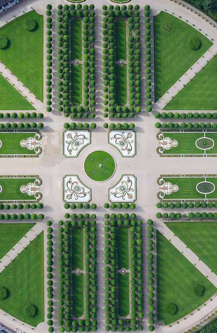 an aerial view of a park with lots of green grass and trees in the middle