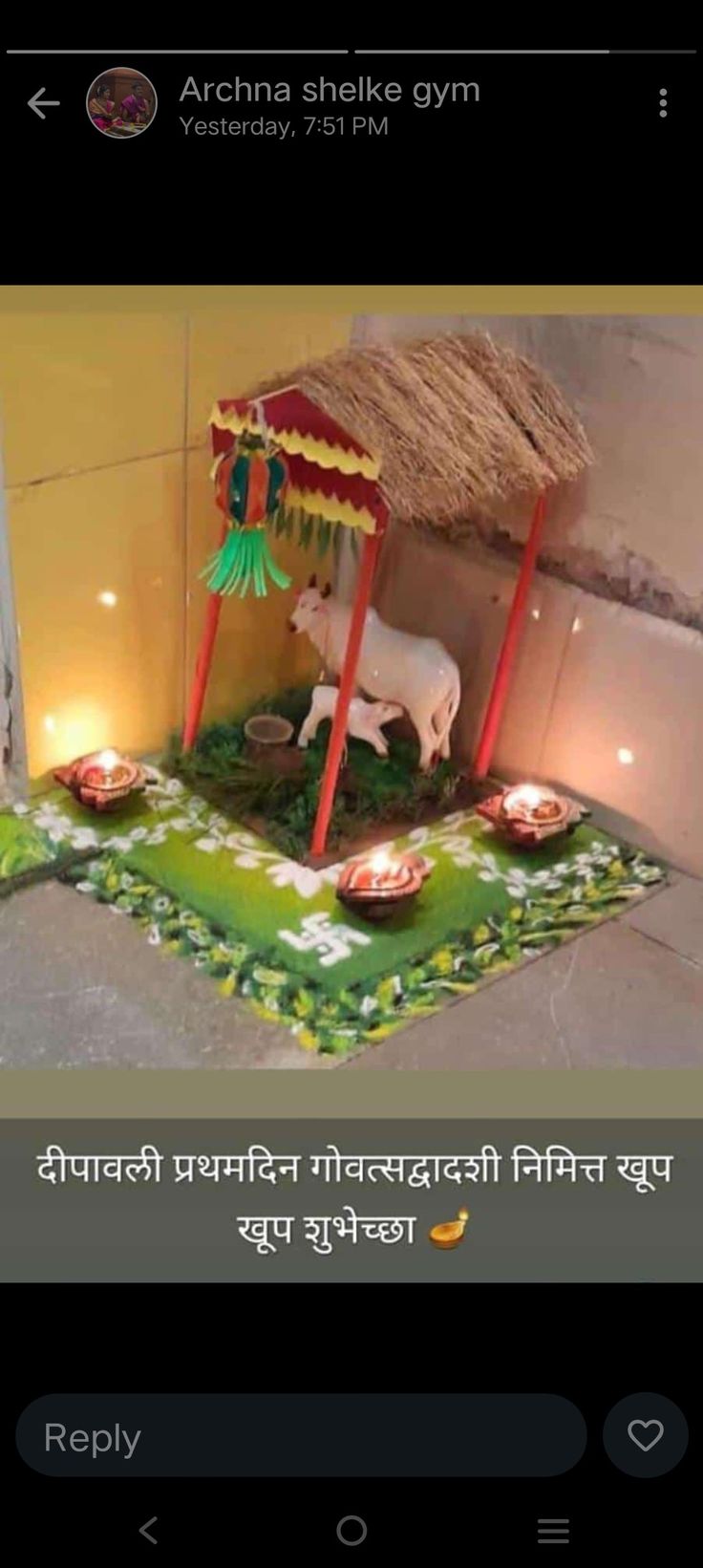 a cow statue sitting on top of a lush green field next to a small hut