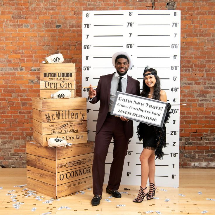 a man and woman standing next to each other holding a sign