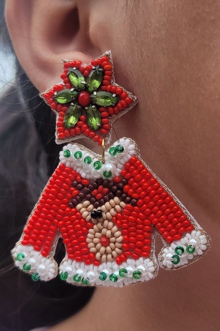 We only have limited quantities of these! Beaded-Lightweight!  Handcrafted Christmas Sweater Earrings!  Featuring Rudolf and his red nose, these Christmas sweater earrings are the icing on top of your holiday outfit!   Earrings are approximately 2.5 inches long and 2 inches wide at the widest point.  This is a handcrafted item and ships from a family owned small business in Texas. Red Novelty Christmas Jewelry, Red Novelty Jewelry For Christmas, Red Earrings For Winter Gift, Novelty Red Christmas Jewelry, Red Christmas Novelty Jewelry, Handmade Beaded Earrings For Christmas, Festive Christmas Beaded Earrings, Fun Red Beaded Earrings For Gift, Christmas Party Beaded Earrings With Round Beads