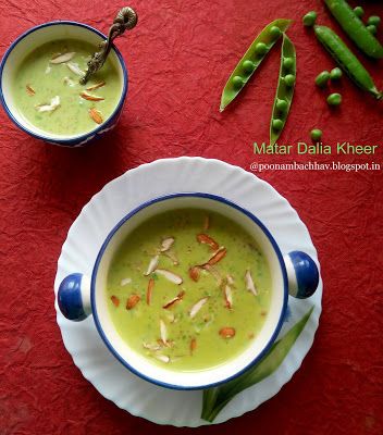 two bowls filled with green soup on top of a red table next to pea pods