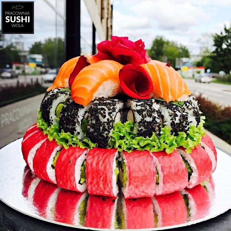 sushi platter with various types of sushi arranged on the top and bottom