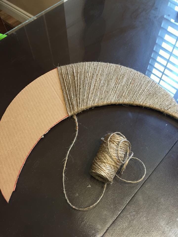 a spool of twine sitting on top of a table next to a roll of string