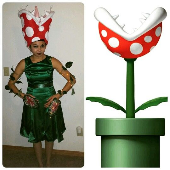 a woman in a green dress standing next to a red and white mushroom plant with her hands on her hips