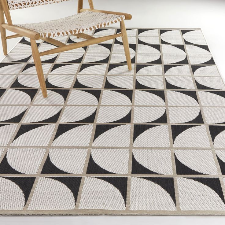 a chair sitting on top of a black and white rug