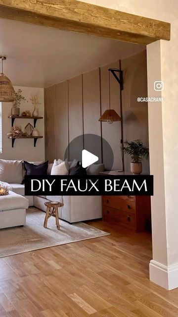 a living room with white couches and wooden beams in the ceiling is featured on an advertiser's video