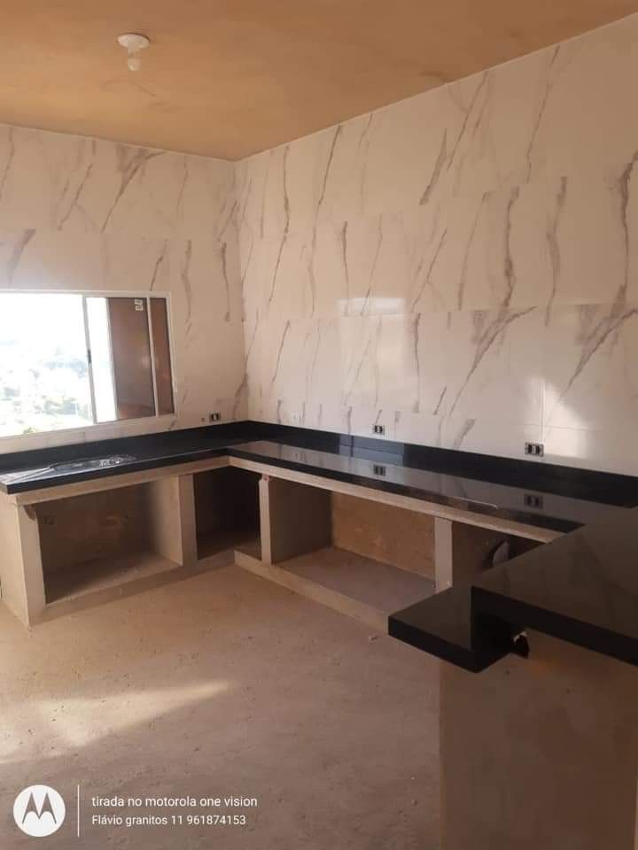 an empty room with marble walls and counters