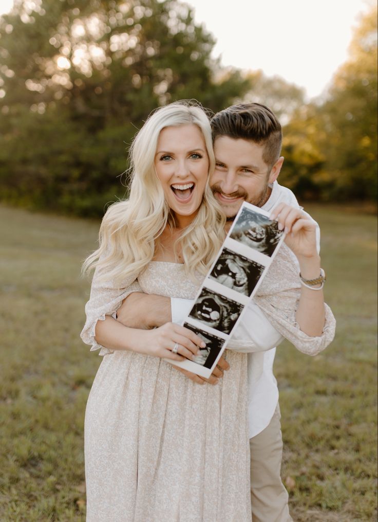 a man and woman holding an old photo