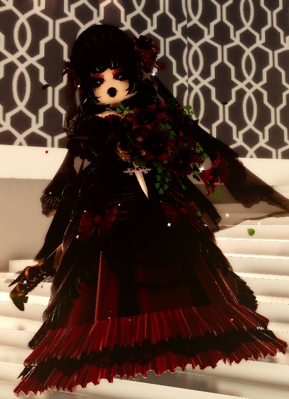 a doll is dressed in black and red with flowers on her head, sitting on some white steps