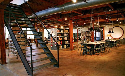 an empty library with stairs and tables