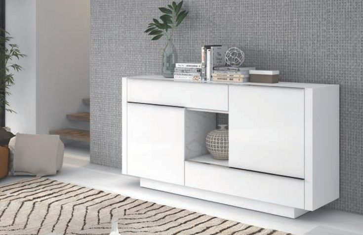 a living room with a white cabinet and rugs on the floor in front of it