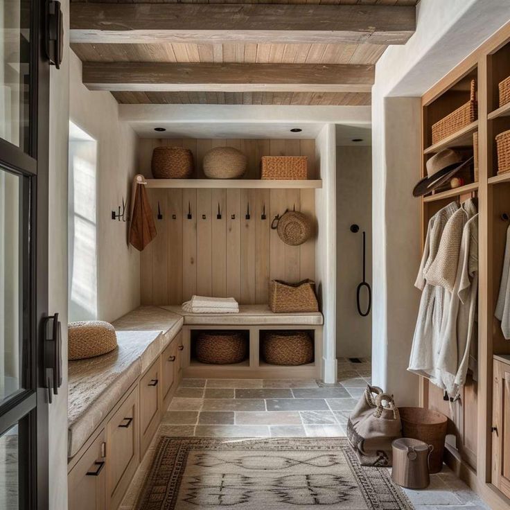 the inside of a mud room with lots of storage space and baskets on the shelves