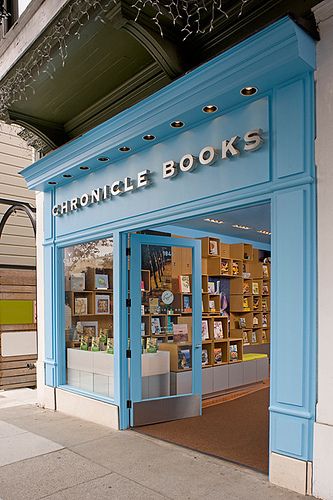 the front entrance to a book store with blue doors