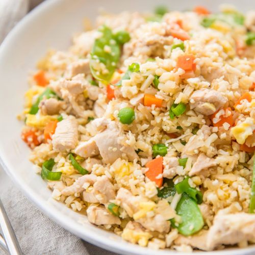 a white bowl filled with rice and vegetables