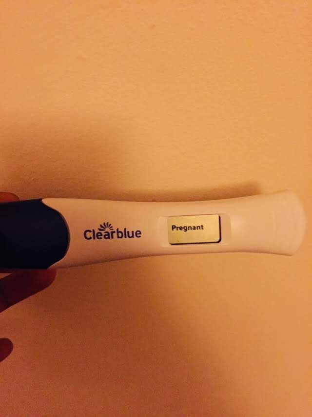 a person holding an electronic toothbrush in their left hand with the word clearblue written on it