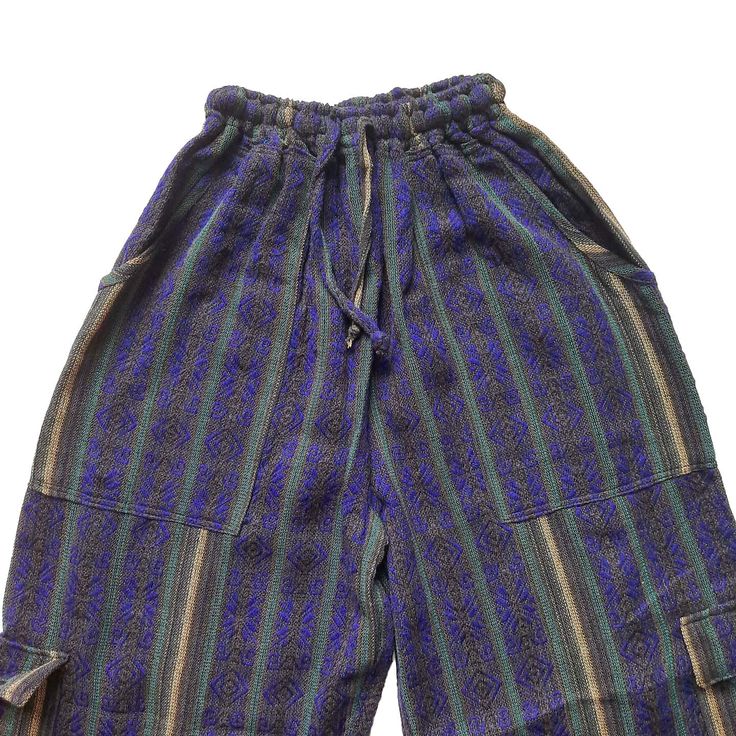 Nice comfy pants for going to the beach, camping, or spending the day at home.These hippie pants have 2 pockets on the front + 2 cargo pockets +1 pocket on the back.They are high-waisted boho pants. They have a drawstring in the waist. It was handmade by Ecuadorian artisans using the foot-treadle loom technique.Materials:75% cotton and 25% acrylic Measurements:Waist circumference: stretches from 24" up to 34"Hip circumference: 42"Rise: 11"Inseam: 28"Total Length: 39"Thigh: 12"Leg opening: 8" Car Bohemian Wide Leg Cargo Pants With Pockets, Bohemian Bottoms With Pockets For Vacation, Bohemian Wide-leg Cargo Pants, Cotton Beach Pants With Cargo Pockets, Cotton Cargo Pants For Beach, Bohemian Relaxed Fit Parachute Pants With Pockets, Green Harem Pants With Pockets For Vacation, Bohemian Summer Cargo Pants With Pockets, Bohemian Wide Leg Cargo Pants For Summer