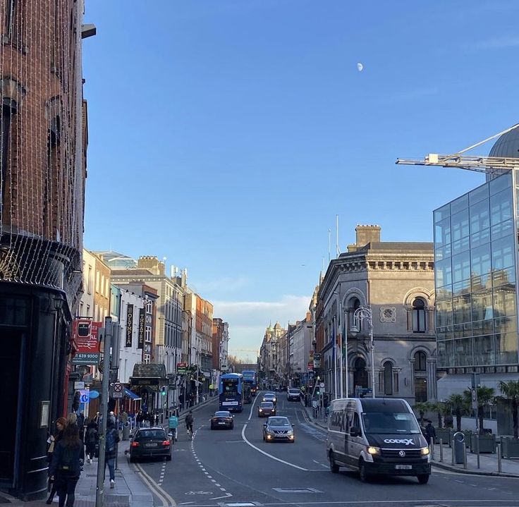 a busy city street with cars driving down it