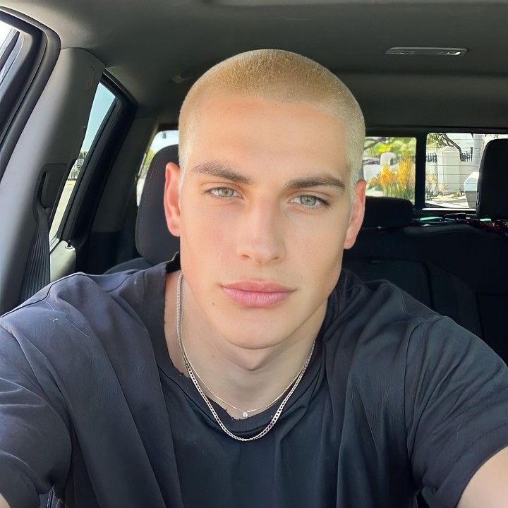 a man sitting in the back seat of a car