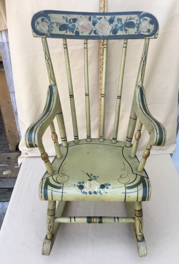 an old wooden chair sitting on top of a table