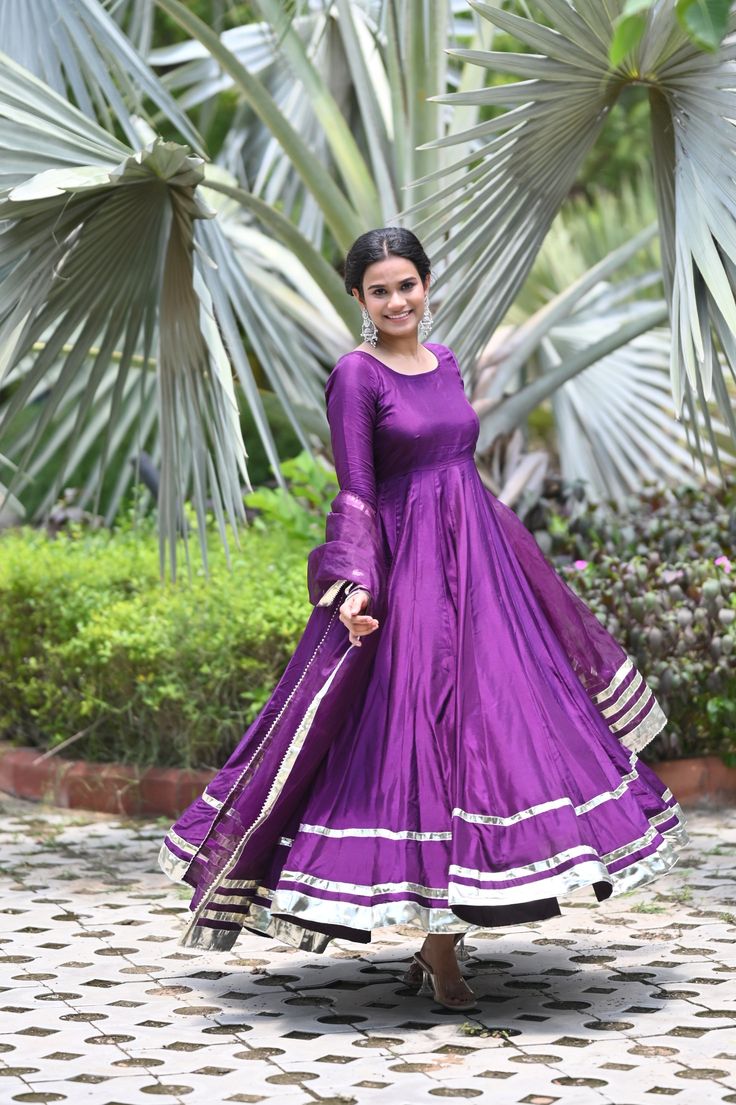 PRODUCT DESCRIPATION This festive season , be ready to impress! Shop it now and make Diwali memorable!Anarkali :- Upada silkPant :- CottonDupatta :- Organza silkClosure Used:- Side zipColor:- Deep purpleCare Instructions :- Dry clean onlyModel Size :- Model is wearing XS sizeModel Height :- 5.5'DISCLAIMER :- Slight color variations may occur due to different screen resolution. Party Anarkali Set With Zari Work In Katan Silk, Katan Silk Anarkali Set With Zari Work For Party, Bollywood Style Floor-length Cotton Silk Salwar Kameez, Unstitched Tissue Silk Anarkali Set For Celebration, Festival Party Anarkali Set In Katan Silk, Festive Purple Anarkali Set For Navratri, Purple Bollywood Salwar Kameez In Art Silk, Celebration Anarkali Set With Zari Work In Tissue Silk, Tissue Silk Anarkali Set With Zari Work For Celebration