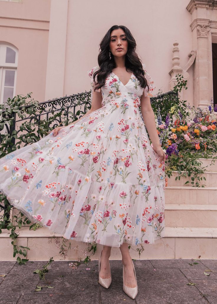 Happily Ever After Our best-selling Jeanne Dress is making her spring debut in a beautiful bight white color with one of a kind floral embroidery. This is a dress designed for the girl who loves to stand out. A slight open back completes the look with feminine charm. V neckline Sleeveless Empire waist Back zipper Runs Feminine Floral Embroidered Dress For Garden Party, Spring Floral Print Maxi V-neck Dress, Summer Dress With Sweetheart Neckline For Casual Occasions, Summer Wedding Midi Dress With Floral Embroidery, Summer Dress With Sweetheart Neckline For Casual Wear, Summer Dress Down Dress With Sweetheart Neckline, Feminine Embroidered Midi Dress For Garden Party, Spring Floral Print V-neck Sundress, Spring Floral Embroidery Midi Dress