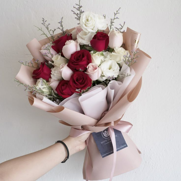 a person holding a bouquet of flowers in their hand