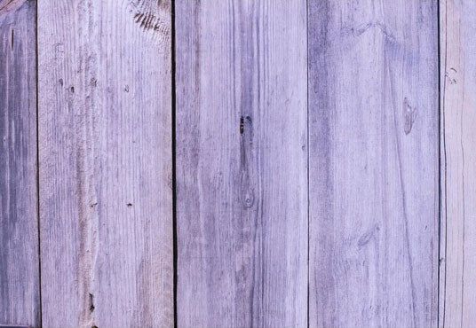 an old clock is on the side of a wooden wall