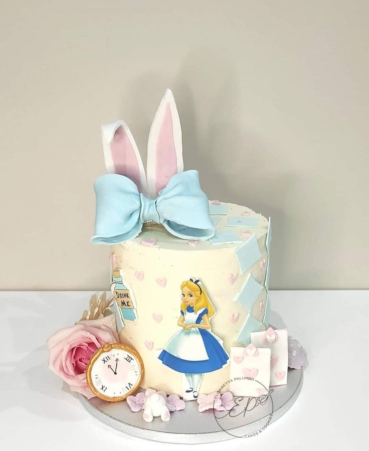 a cake decorated with an image of alice in wonderland